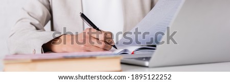 partial view of interpreter translating document on blurred foreground, banner Royalty-Free Stock Photo #1895122252