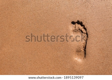 Human footprint in the sand on Mars. Life on the red planet. Male foot on the beach, top view. Copy space for text and design