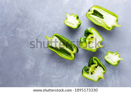 Ugly bell pepper on ultimate gray background. Sliced bell pepper halves on the table. Non GMO vegetables. Copy space