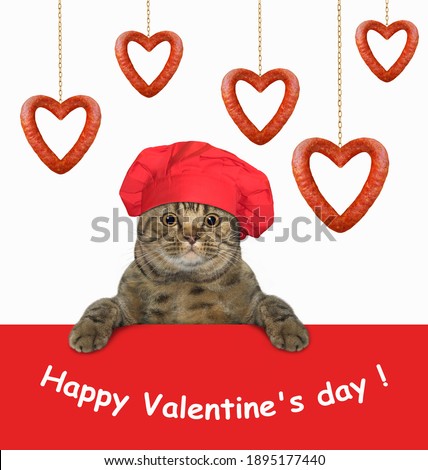 A beige cat in a red chef hat is near a heart shaped hanging sausages. Happy Valentine's day. White background. Isolated.
