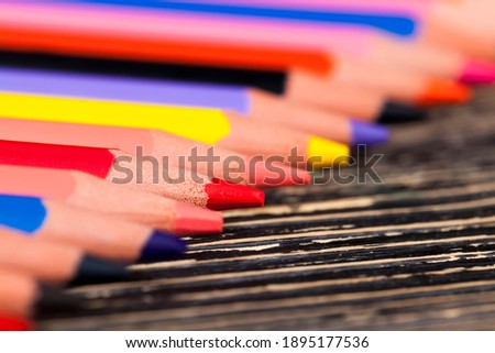  colored wooden pencil with soft lead of different colors for drawing and creativity, closeup of pencils after sharpening and use, pencil made of natural eco-friendly materials safe for children