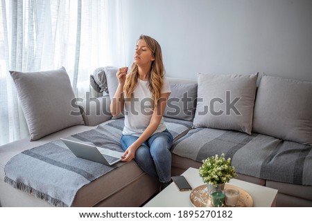 Woman self test for COVID-19 home test kit. Coronavirus nasal swab test for infection. Telemedicine and Telehealth distribution of health-related services online. Internet doctor in video call Royalty-Free Stock Photo #1895270182