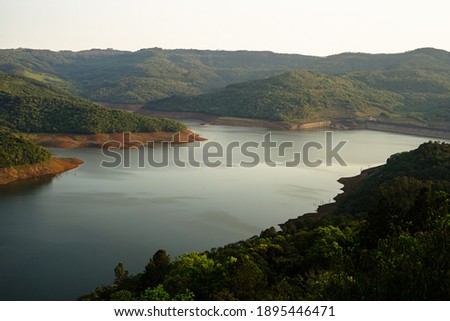 Iguaçu River, with low water level, surrounded by vegetation, in the municipality of Pinhão, southern region of Brazil. Royalty-Free Stock Photo #1895446471