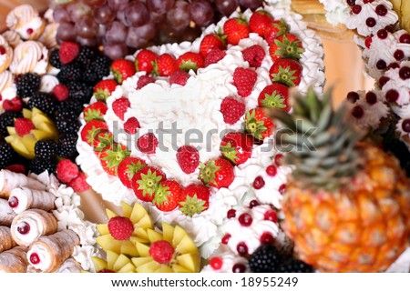 Fancy-cakes with whipped cream decorated with fruit