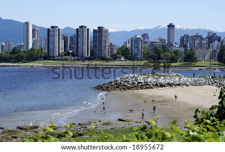 The beach for dogs and their owners with Vancouver downtown skyline in a background (British Columbia, Canada).