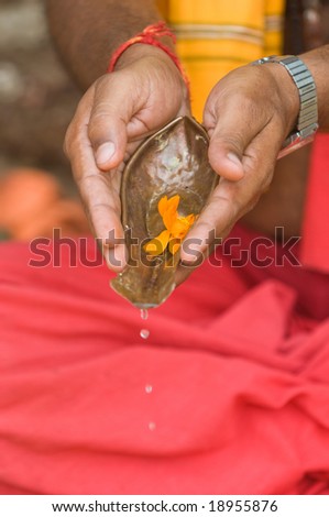 Devotee  hands with Holy Water