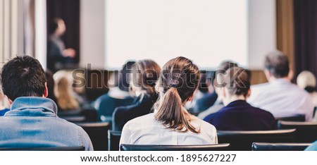 Speaker Giving a Talk at Business Meeting. Audience in the conference hall. Business and Entrepreneurship. Panoramic composition suitable for banners. Royalty-Free Stock Photo #1895627227