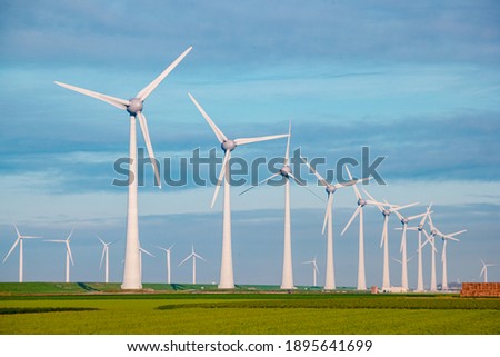Windmills for electric power production Netherlands Flevoland, Wind turbines farm in sea, windmill farm producing green energy. Netherlands Royalty-Free Stock Photo #1895641699