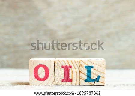 Alphabet letter block in word oil on wood background
