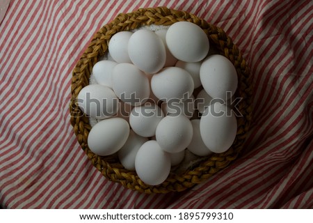 basket with field eggs on striped tablecloth