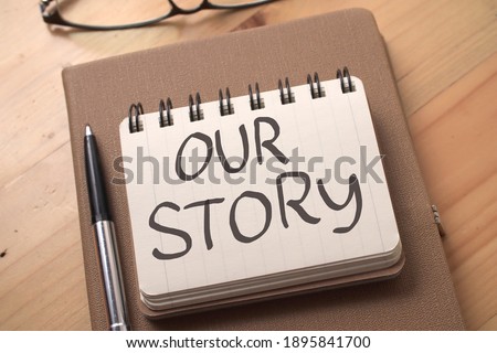 Our story, text words typography written on book against wooden background, life and business motivational inspirational concept Royalty-Free Stock Photo #1895841700
