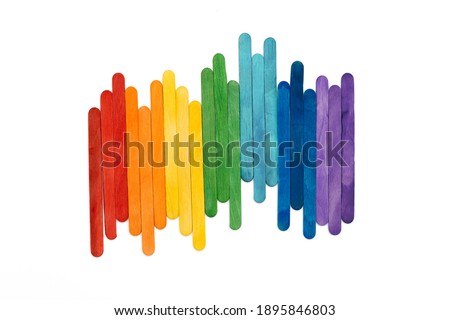 Rainbow color wooden ice cream sticks on white. Multicolored abstract  lgbt concept.