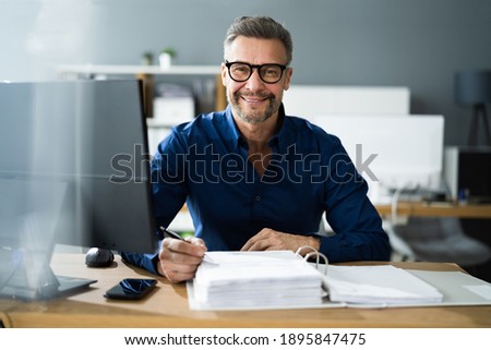 Tax Accountant Advisor Man Doing Sales Invoice Accounting Royalty-Free Stock Photo #1895847475