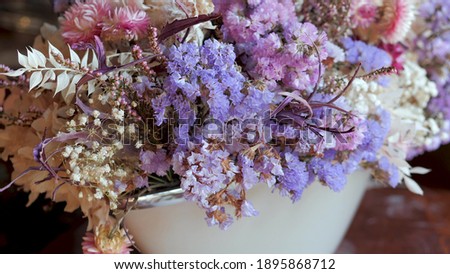 Bouquets with white, purple and violet dried flowers and leaves for sale in flower shop. Assortment for decoration and congratulation