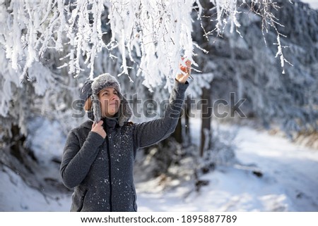 Portrait of young woman in magic, frozen winter landscape.
