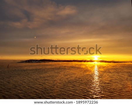 Reflections of sunset with cloudscape in lake water.

