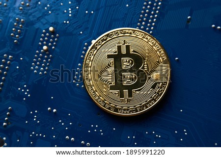 Bitcoin coin on blue circuit background. Cryptocurrency, virtual money. Blockchain technology, bitcoin mining concept Royalty-Free Stock Photo #1895991220