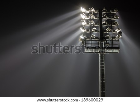 Stadium lights against dark night sky background 