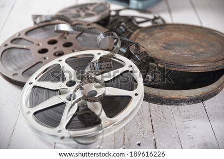 several films and coils placed on an old white wooden table