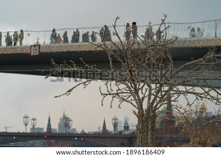Photography of the Observation Deck Zaryadye Park. People enjoy view, make images. International touristic concepts. Moscow  had been decorated to New Year holidays. Red Kremlin Towers as background