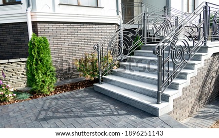 entrance to the building. Iron banister. Elements railing of a beautiful country house, Villa. staircase step with steel handrail. Royalty-Free Stock Photo #1896251143