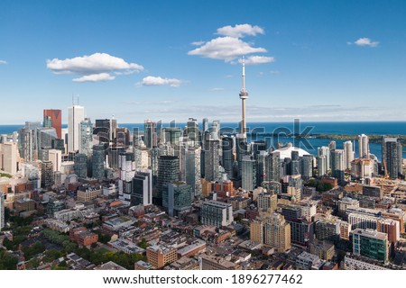 Toronto, Ontario, Canada, daytime aerial view of Toronto cityscape including architectural landmark CN Tower and modern high rise buildings in the financial district. 