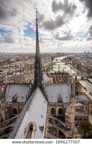 Notre-Dame Spire, La Fleche, and lead clad wooden roofs before the fire. Cityscape with the Seine River and bridges. Paris, France.