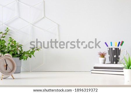 An office by an empty wall. Home Office. School desk. Copy space. Plants at home.