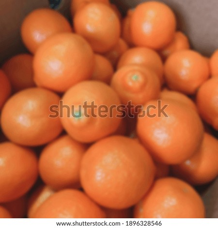 a pile of fresh citrus fruit orange blur . Blurry background 