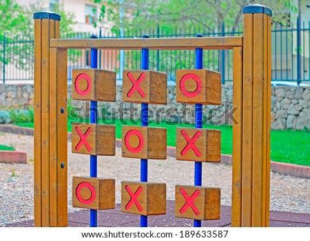 wooden tic tac toe in a green park