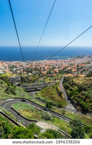 Funchal town and streets viewed from above, orange roofs and palm trees, Madeira Island