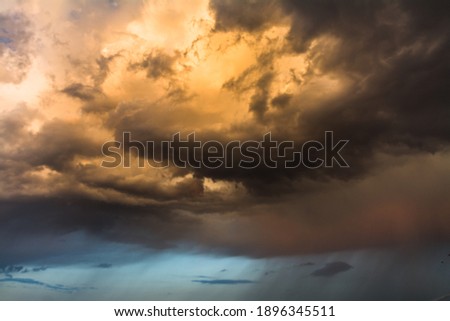 golden clouds interchanged with blue sky before a storm