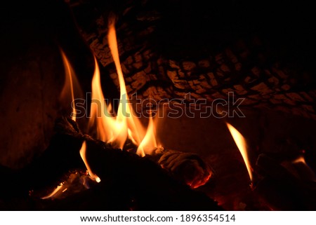 Warm fire and sparks in a fire-place from conflagrant wooden logs