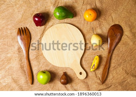 Combination of leaves and fresh fruits. Simple and elegant framing of fruit and leaves. Wallpaper that attracts the eye, commonly used for design templates, mockups and invitations. Jungle Fruits.