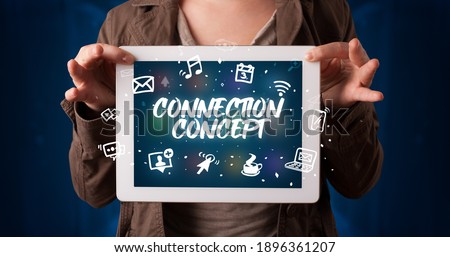 Young business person working on tablet and shows the inscription: CONNECTION CONCEPT