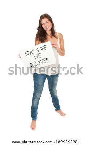 Full length portrait of a beautiful young woman holding a placard, stay safe we deliver is written on the paper, isolated on white studio background