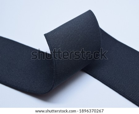 Black Knit Elastic Spool for needlework of the cloth insulated on black background. Royalty-Free Stock Photo #1896370267