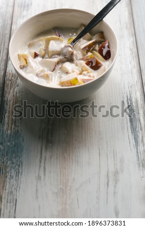 Healthy and nutritious homemade breakfast - fruit yogurt with apples and walnuts. Copy space left. 