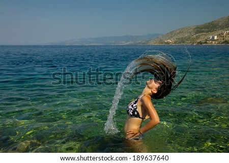 Woman splashing water in the sea