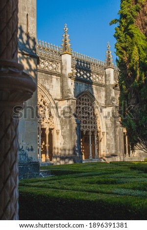 view on a courtyard of an ancient portugal monastery with facade full of bas-reliefs