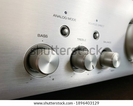 Stereo audio amplifier with tone block close-up.