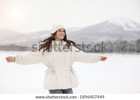 Portirait of a young happy woman. Enjoying nature, wintertime