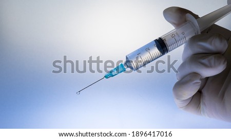 Coronavirus (COVID 19) Vaccine and syringe injection.
Close up vaccination vial dose flu shot drug needle syringe.  Royalty-Free Stock Photo #1896417016