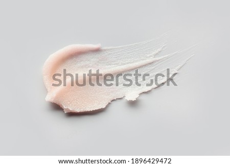 Cosmetic lip balm, salt or sugar scrub swatch on gray background Royalty-Free Stock Photo #1896429472