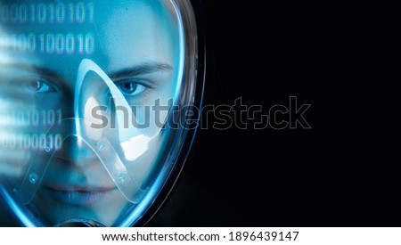 Beautiful woman in futuristic costume over dark background. Girl in 3d glasses of virtual reality. Augmented reality, game, future technology, AI concept. VR. Blue neon light.