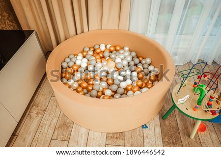 Dry children's pool with balls in the children's room