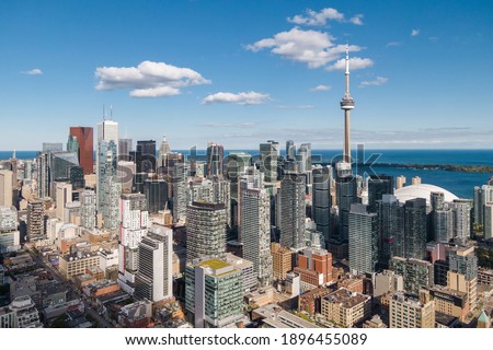 Toronto, Ontario, Canada, daytime aerial view of Toronto cityscape including architectural landmark CN Tower and high rise buildings in the financial district.