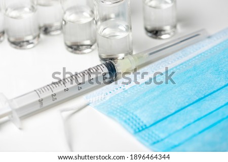vaccine vial a illustrative picture, doctor in the laboratory with a biological tube for analysis and sampling of Covid-19 infectious disea. syringes, ampoules, covid-19 vaccination