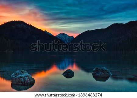 alpsee with a burning sky