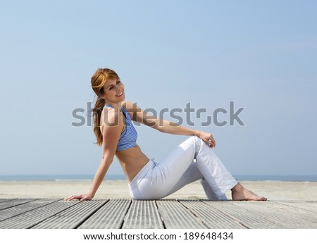 Portrait of a happy middle aged woman smiling at the beach